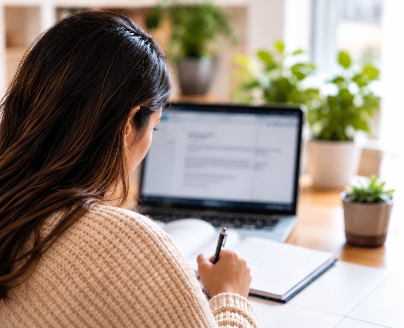 Student preparing workbook exercises at a laptop